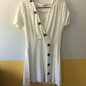 Flattering white linen dress with brown buttons
